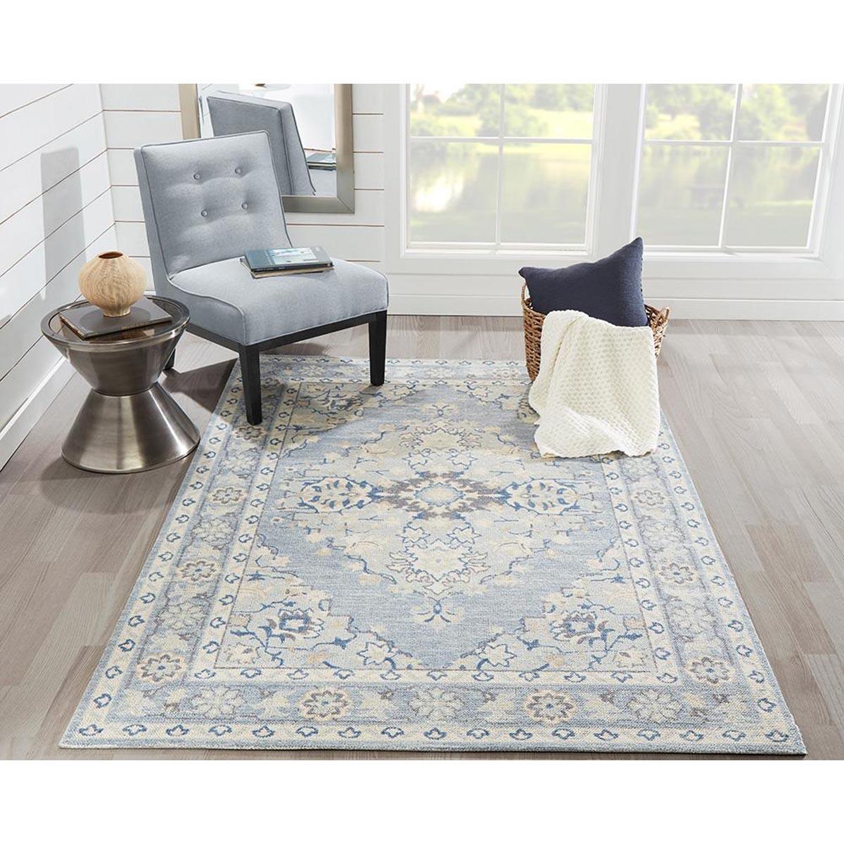 Amherst Rug styled with accent chair and table. Styled view.