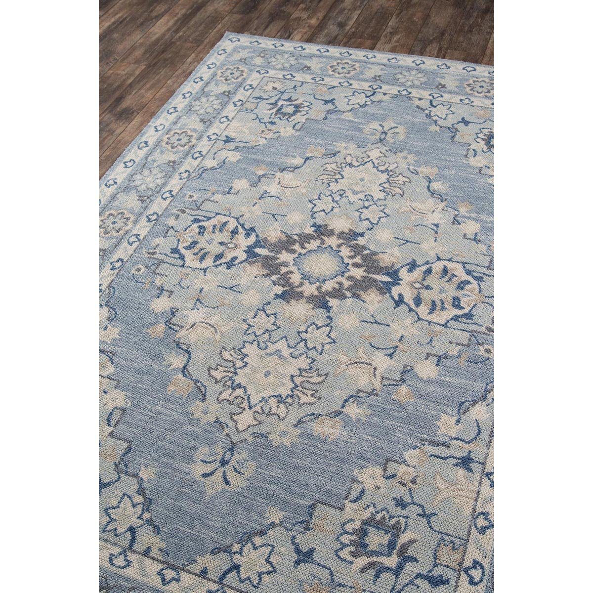 Amherst Rug styled on wood floor. Styled view.