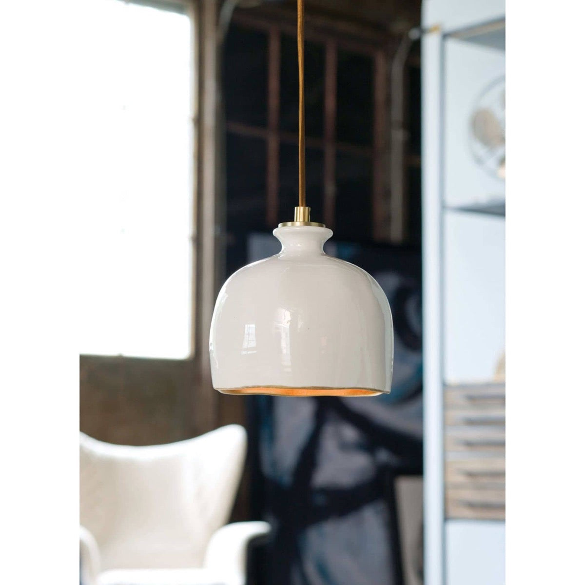 Arden Ceramic Pendant styled in a rustic room. Styled view.