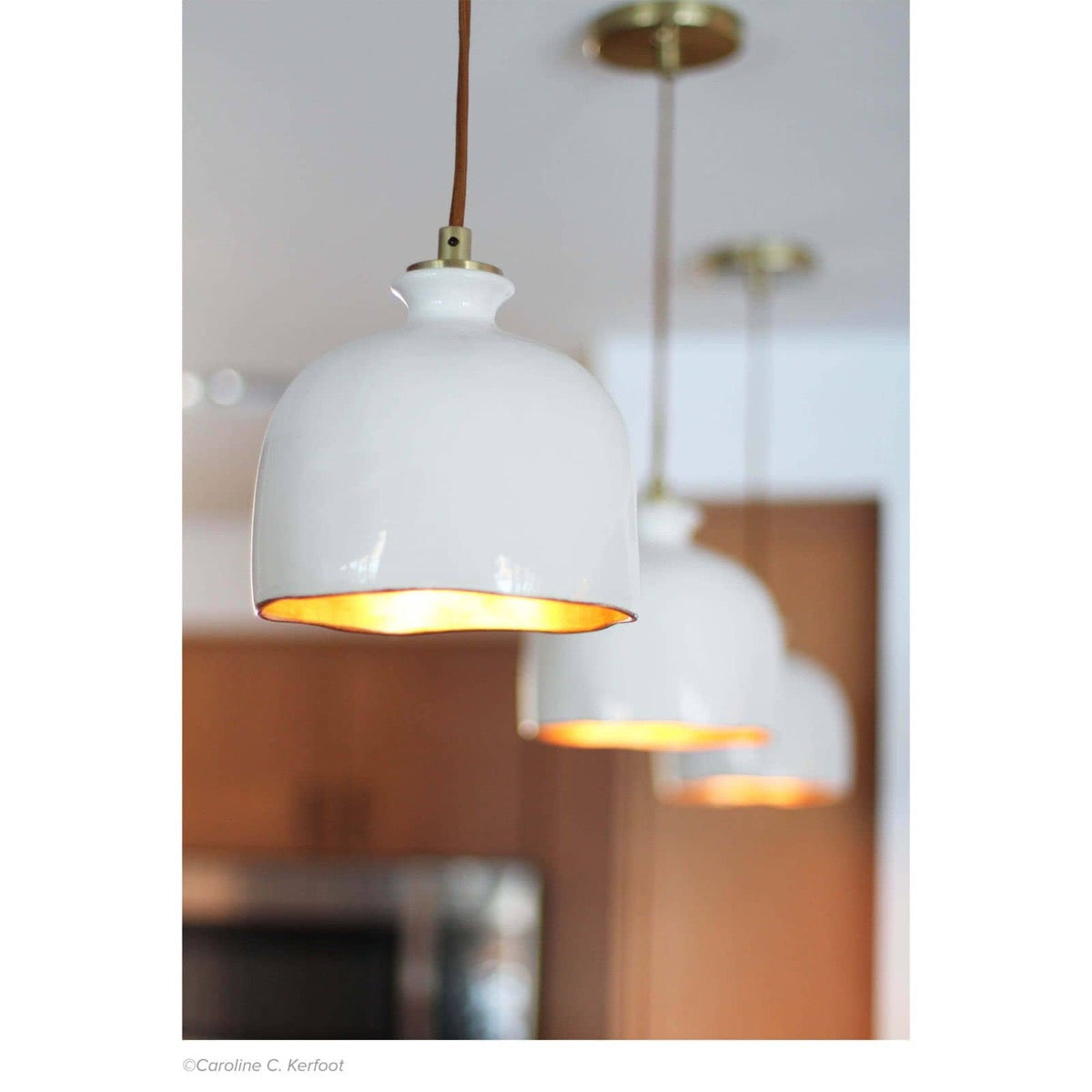 Arden Ceramic Pendant styled in a row in a kitchen. Styled view.