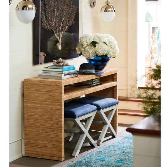 Ashley Console Table styled with blue stools, books and greenery in a hallway. Styled view.
