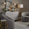 Astoria Dresser styled in a bedroom with grey chairs and gold accents. Styled view.