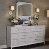 Astoria Dresser styled with neutral wallpaper, florals and a white mirror. Styled view.