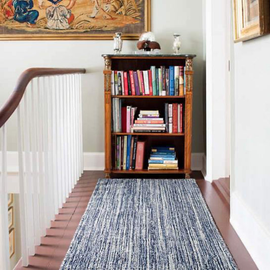 Bella Navy Woven Wool Rug styled in a hallway. Styled view.