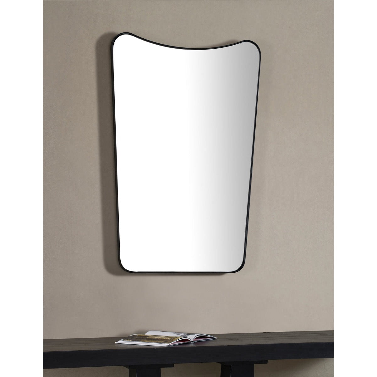 Beth Mirror styled on a neutral wall over a black console. Styled view.