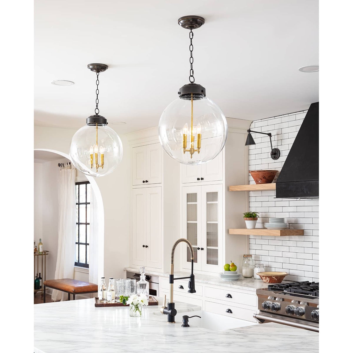 Globe Pendant styled above a white kitchen island. Styled view.