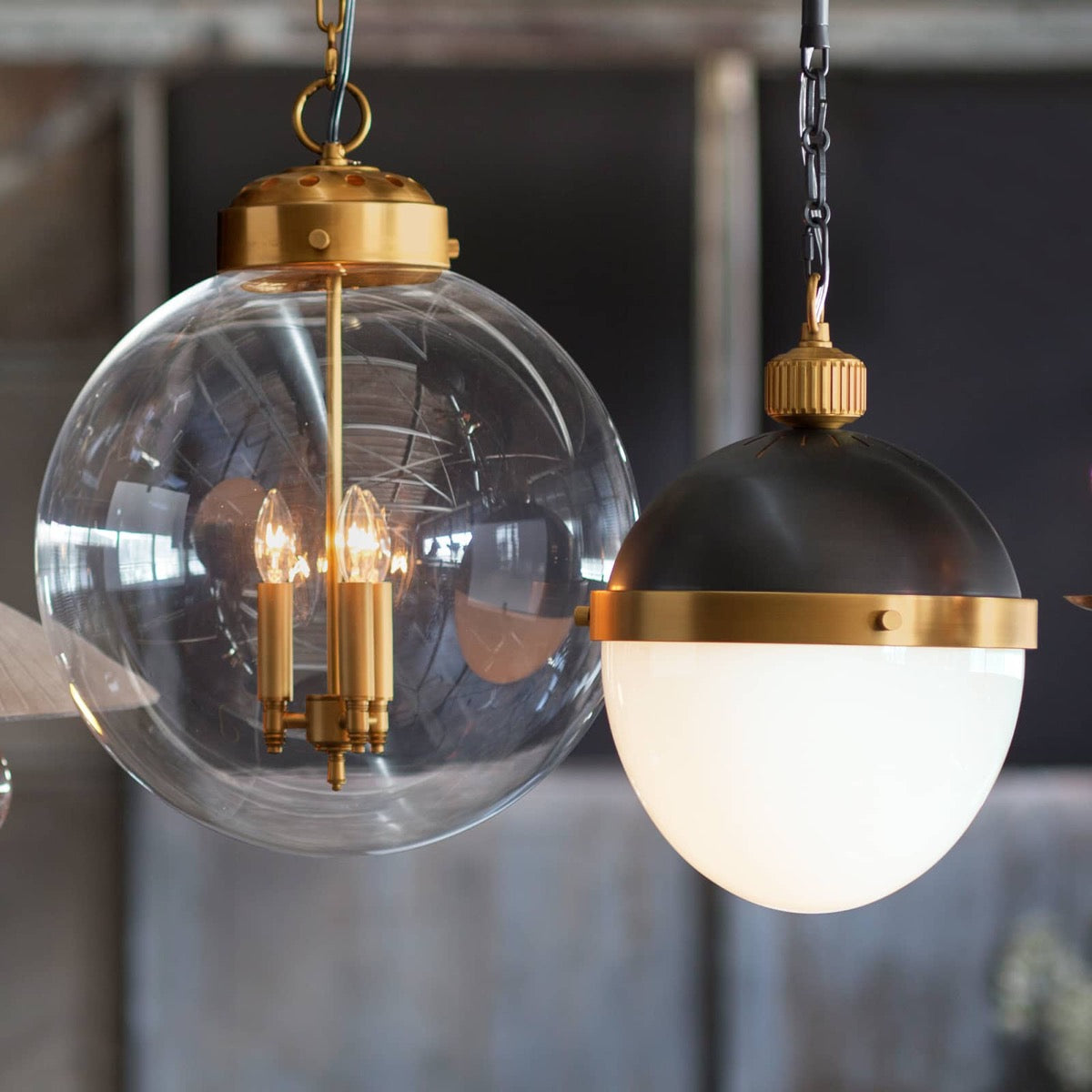Globe Pendant styled with a black and brass pendant. Styled view.