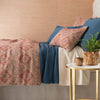 Boyfriend Aegean Matelasse Coverlet styled with pink duvet. Styled view.