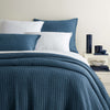 Boyfriend Aegean Matelasse Coverlet stead with white sheets and decor. Styled view.