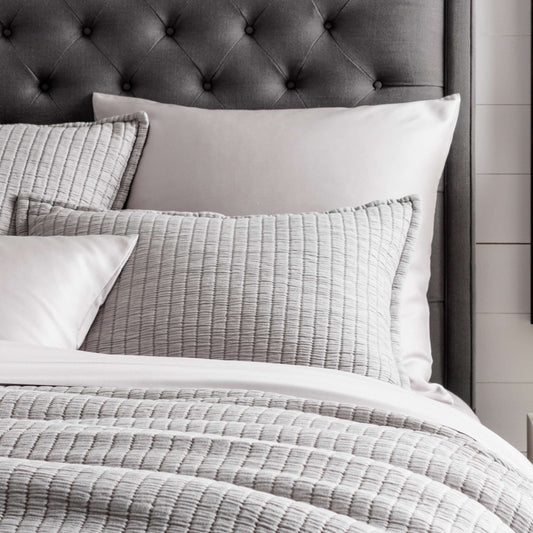 Boyfriend Grey Matelasse Sham styled with grey sheets. Styled view.
