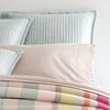 Boyfriend Sky matelasse sham styled with neutral bedding. Styled view.