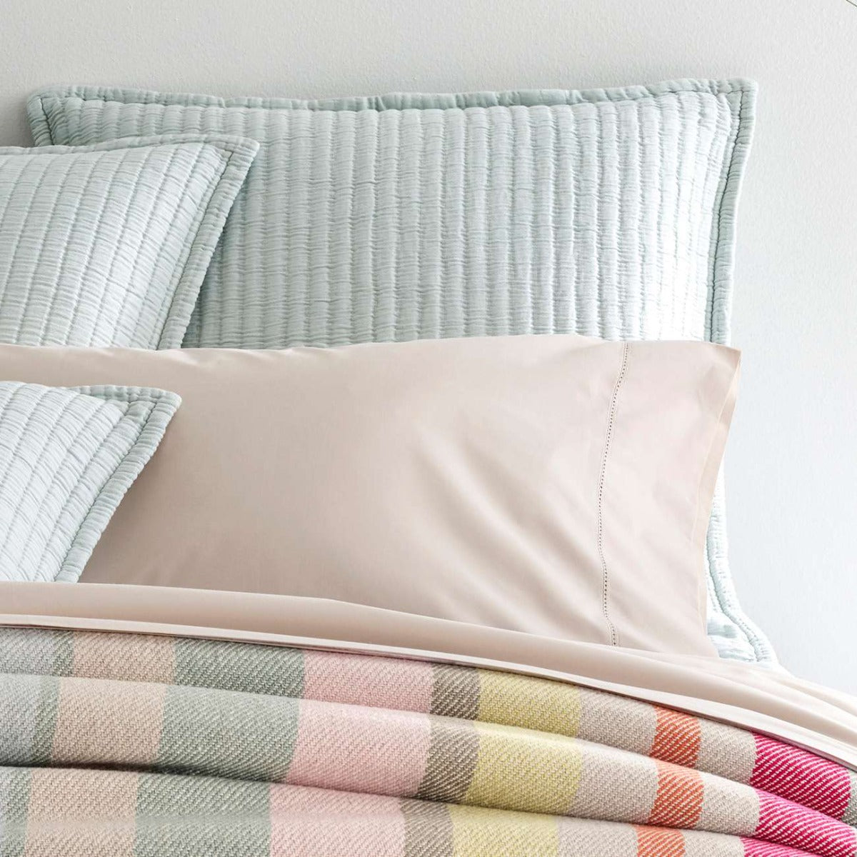 Boyfriend Sky matelasse sham styled with neutral bedding. Styled view.