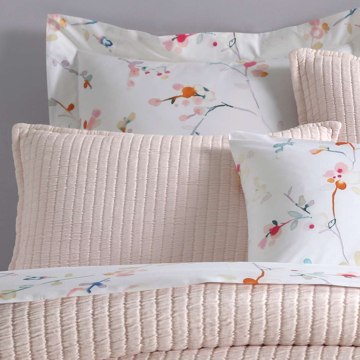 Boyfriend Slipper Pink Matelasse Sham styled with floral sheets. Styled view.