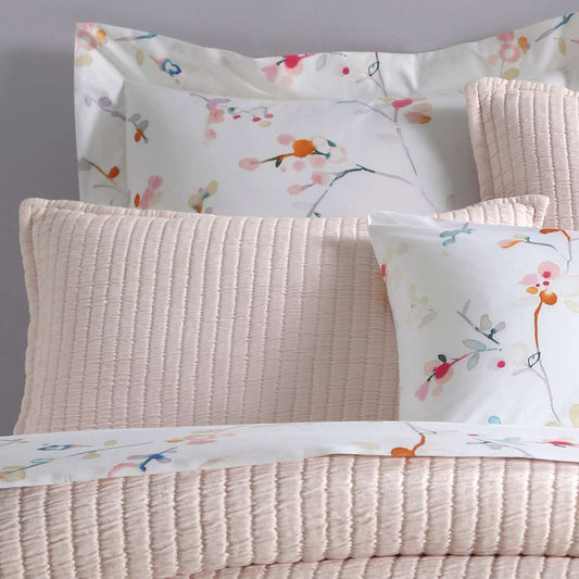 Boyfriend Slipper Pink Matelasse Sham styled with floral sheets. Styled view.