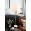 Fisher Stem Buffet Lamp styled on a dark table in a bedroom. Styled view.