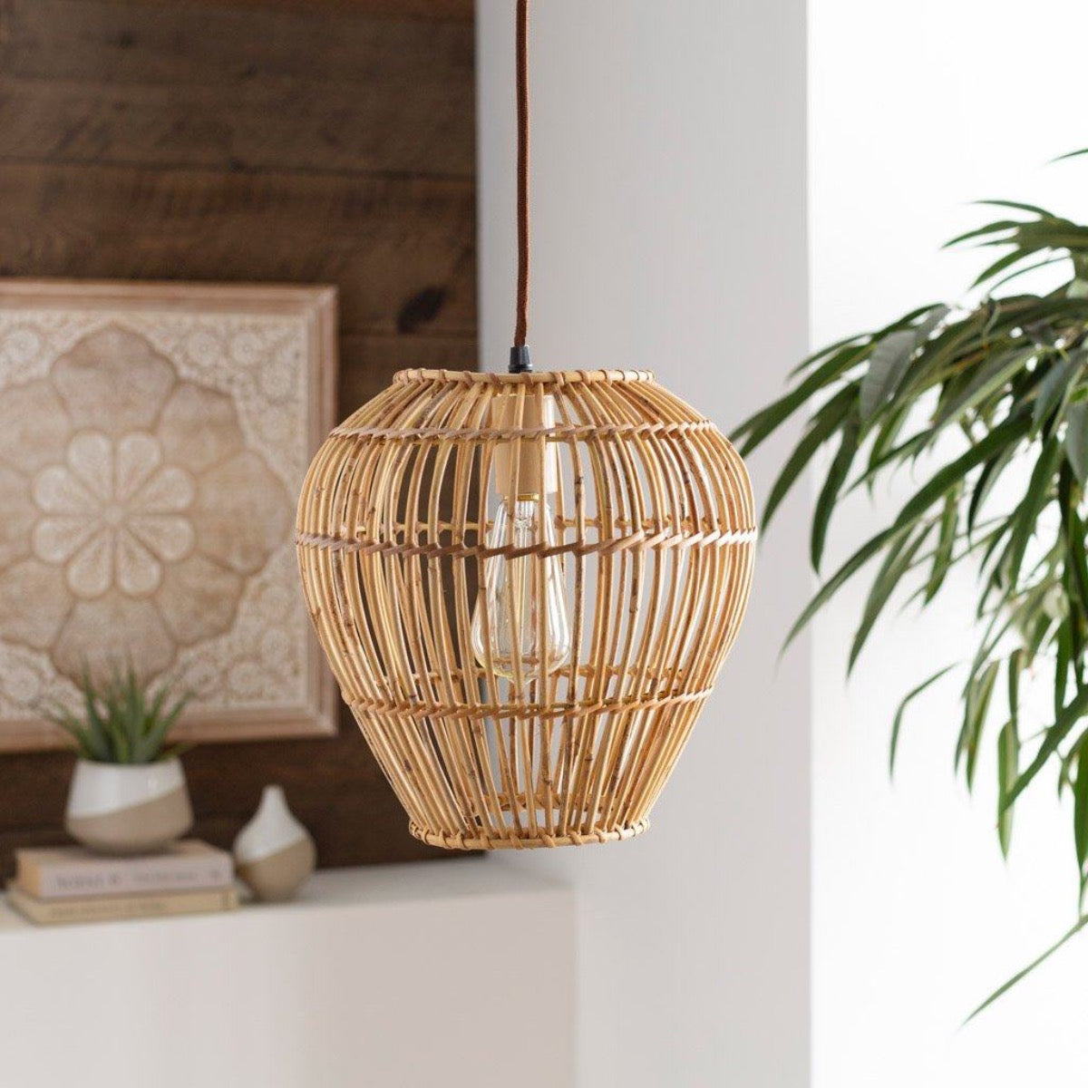 Bungalow Pendant styled in a white room with neutral decor and greenery. Styled view.