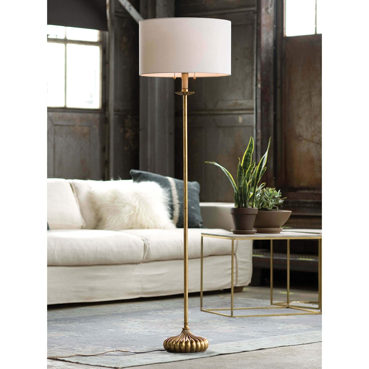 Carson Stem Floor Lamp styled in a industrial living room. Styled view.