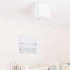 Cleo Flush Mount styled in a nursery with artwork. Styled view.