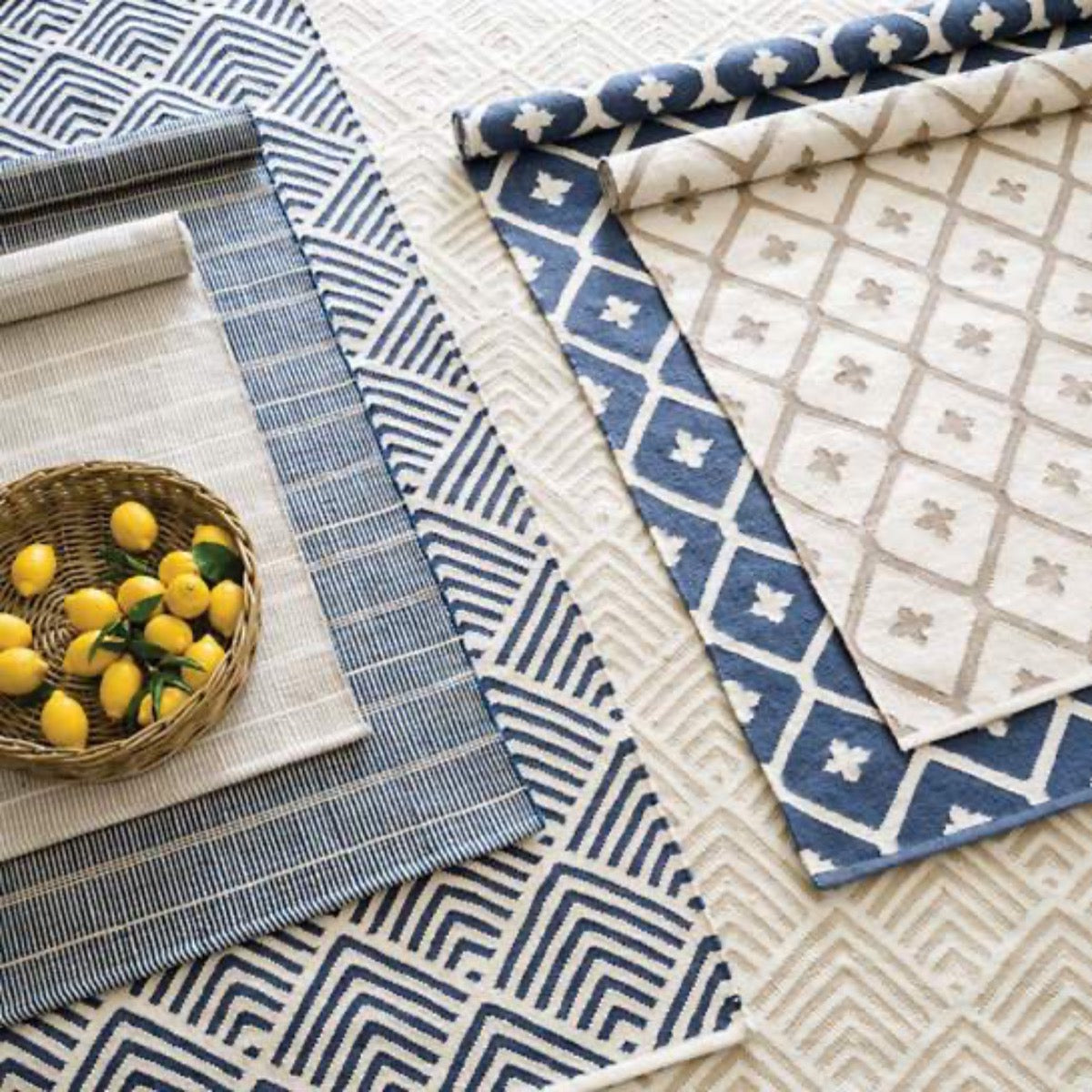 Cleo Navy Indoor/Outdoor Rug styled with blue and cream rugs. Styled view.