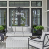 Coleford Outdoor Lantern styled above neutral outdoor seating. Styled view.