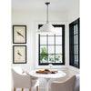 Billie Concrete Pendant - Large styled above a white table with bird artwork and black windows. Styled view.