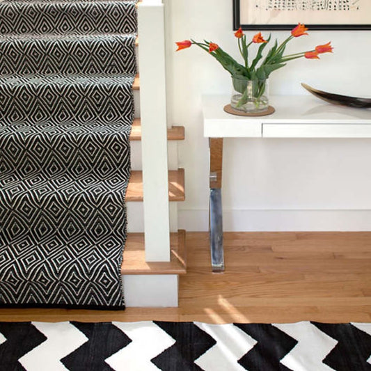 Diamond Black/Ivory Indoor/Outdoor Rug as a runner in an entryway. Styled view.
