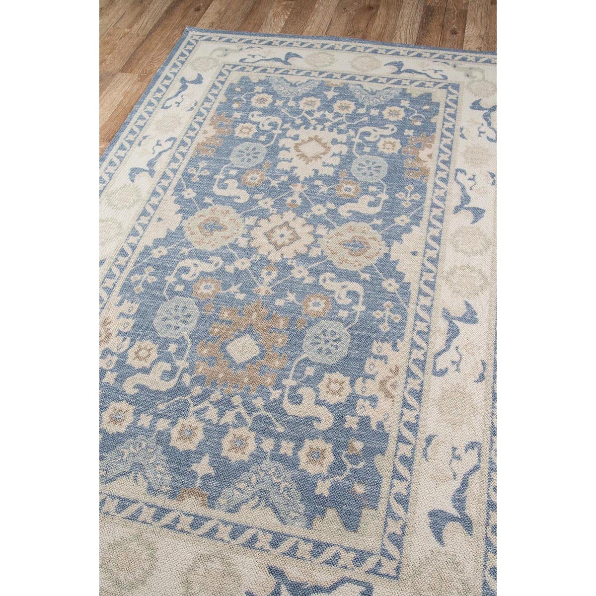 Ellesworth Rug styled on wood floor. Styled view.