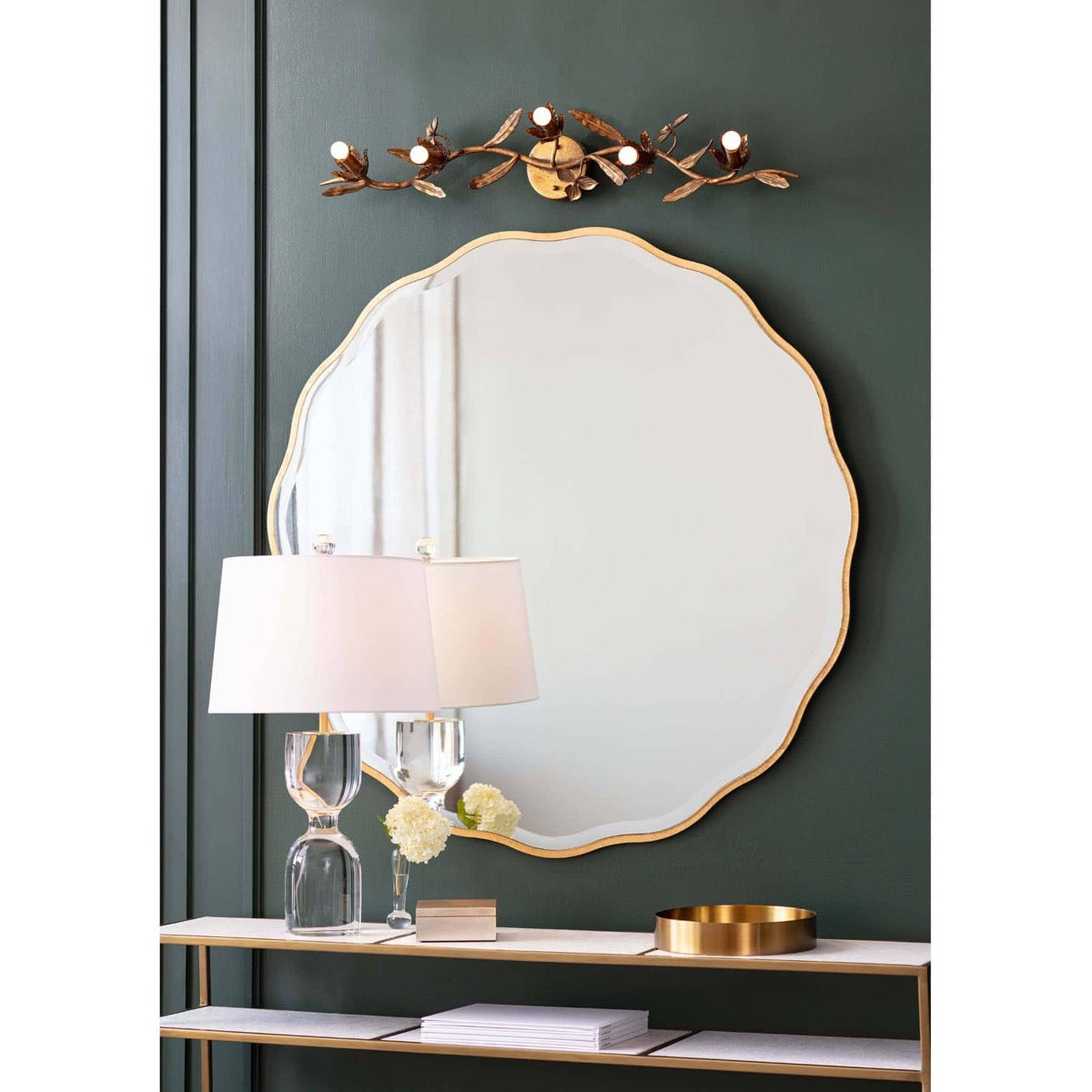Erica Mirror - Large styled on a green wall with gold accents. Styled view.