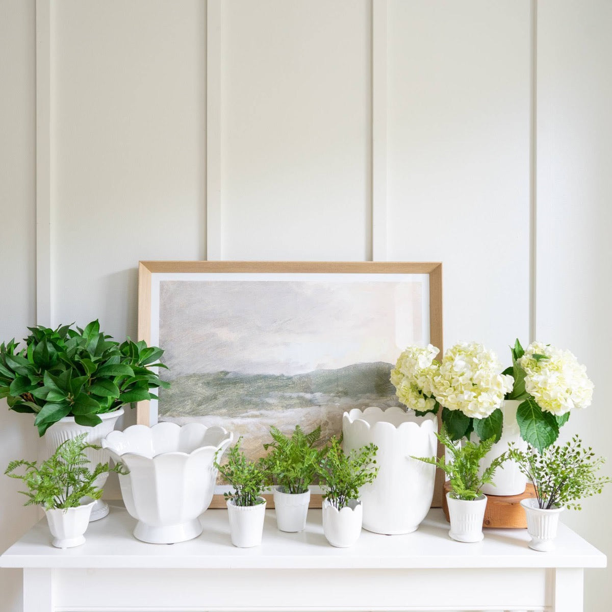 Evening View styled with greenery and white vases. Styled view.