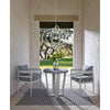 Sail Chandelier styled above a concrete table with grey chairs. Styled view.
