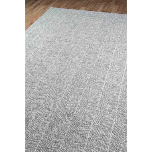 Fletcher Rug - Denim over wood floor. Styled view.