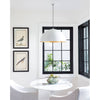 Flynn Pendant - Large White & Gold styled above a white table and chairs with artwork and black windows. Styled view.