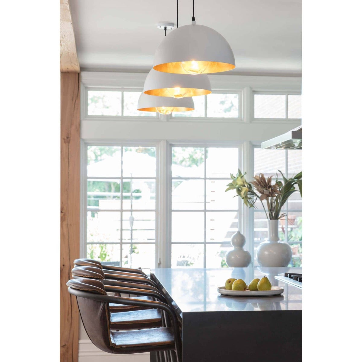 Flynn Pendant - Small White & Gold styled over a black kitchen island with large white windows. Styled view.