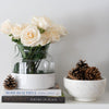 Footed Marble Bowl - Large styled with pinecones, vases and florals. Styled view.