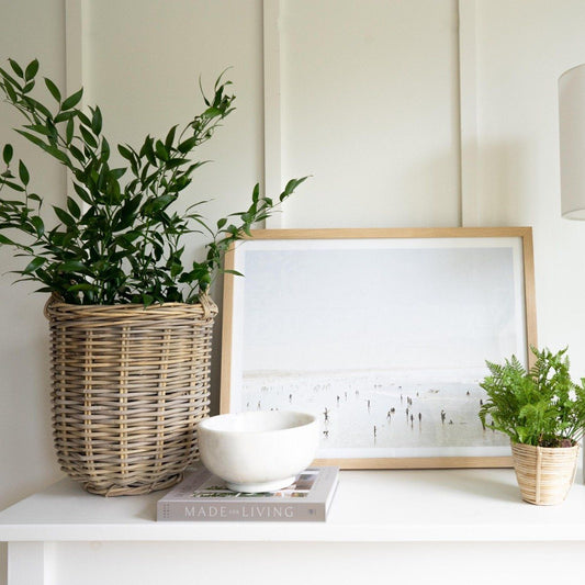 Footed Marble Bowl - Large styled in a white room with artwork and greenery. Styled view.