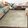 Georgia Rug styled in a neutral living room with throws and greenery. Styled view.