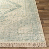 Georgia Rug corner on light wood floor. Styled view.