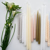 Hand-Dipped Danish Tapers - Olive styled with candles and greenery. Styled view.