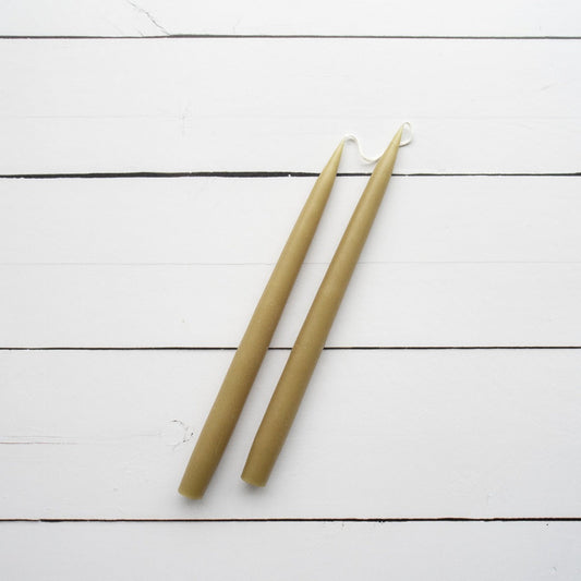 Hand-Dipped Danish Tapers - Olive styled against white wood. Styled view.