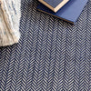 Herringbone Indigo Woven Cotton Rug styled with navy decor. Styled view.