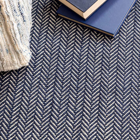 Herringbone Indigo Woven Cotton Rug styled with navy decor. Styled view.