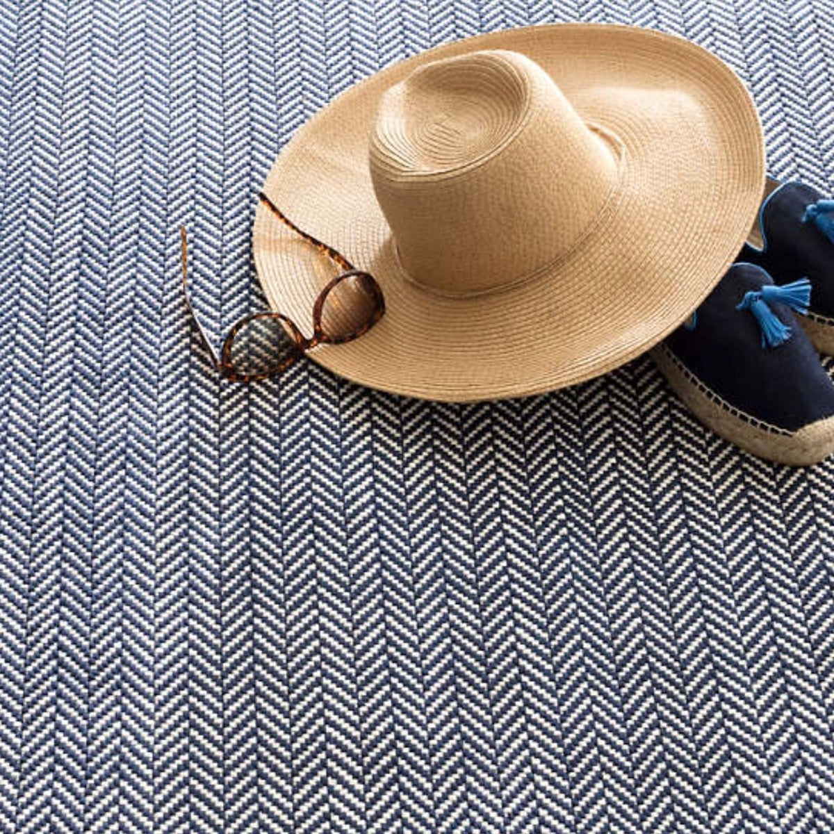 Herringbone Navy/Ivory Indoor/Outdoor Rug styled under clothing. Styled view.