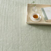 Herringbone Ocean Woven Cotton Rug styled under a wooden tray. Styled view.