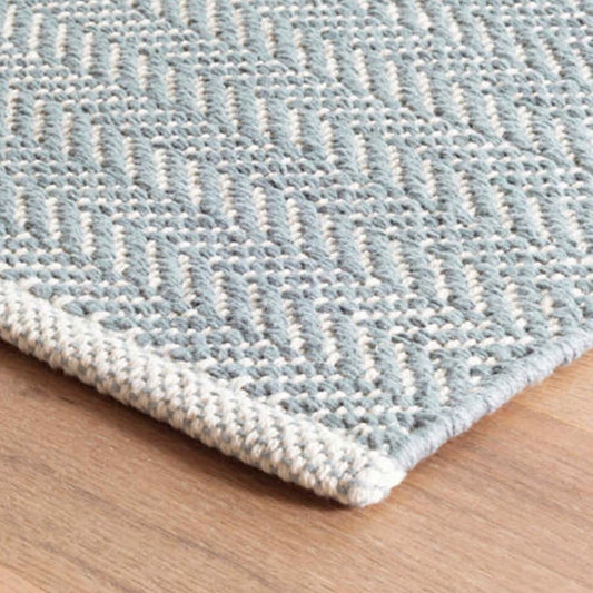Herringbone Swedish Blue Woven Cotton Rug corner detail. Close-up detail view.