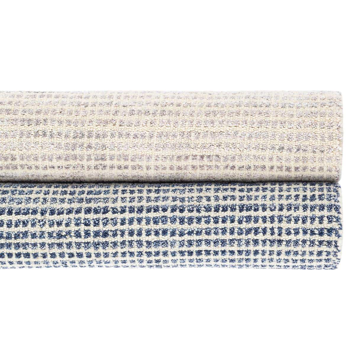 Homer Blue Loom Knotted Wool/Viscose Rug. Styled with a neutral rug. Styled view.