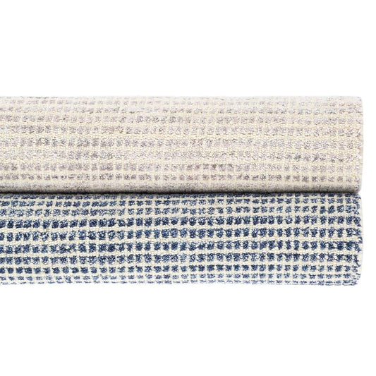 Homer Blue Loom Knotted Wool/Viscose Rug. Styled with a neutral rug. Styled view.