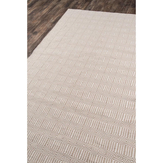 Huron Indoor/Outdoor Rug - Beige over wood floor. Styled view.