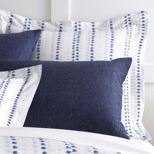 Ink Dots Sham styled with navy sheets. Styled view.