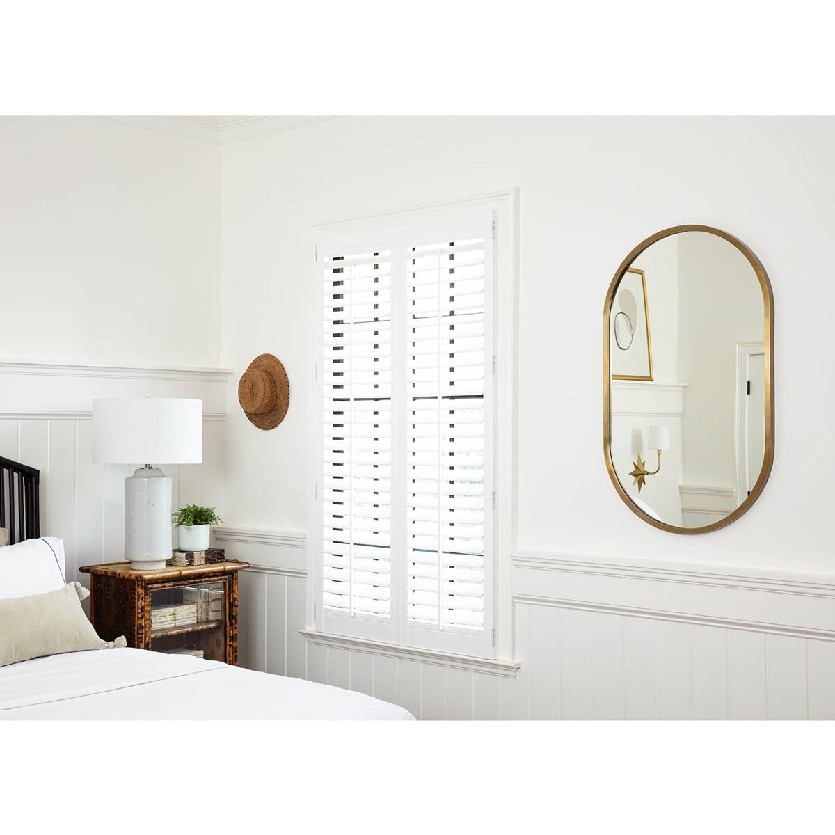 Josie Mirror in a white bedroom. Styled view.