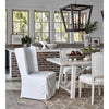 Perennial Lantern styled over a white dining set with decorative fruit bowls. Styled view.